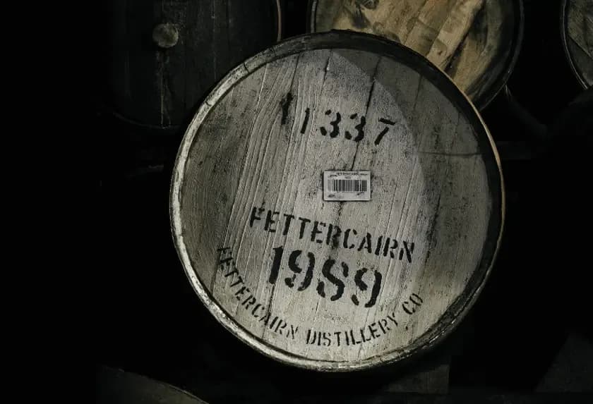 Wooden whisky barrel with 'Fettercairn 1989' and '1337' stenciled on its end.